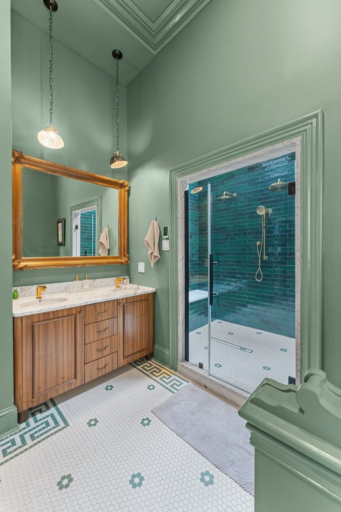 A remodeled small 5x8 Philadelphia bathroom featuring a sleek tub-to-shower conversion with a frameless glass enclosure and large-format wall tile.